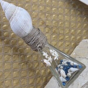 Vintage bottle glass decor with shell and earrings